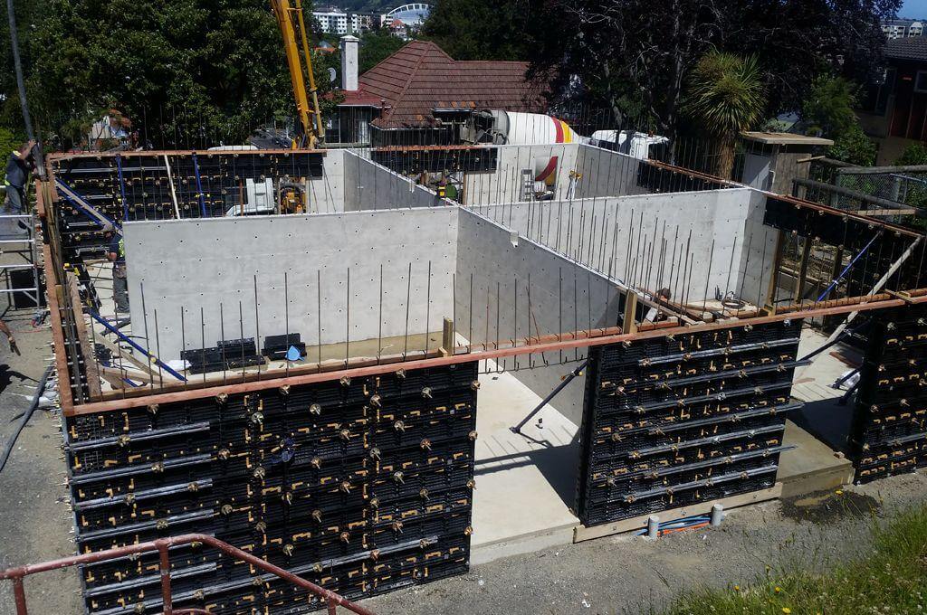 Concrete forming walls pouring concrete into formwork