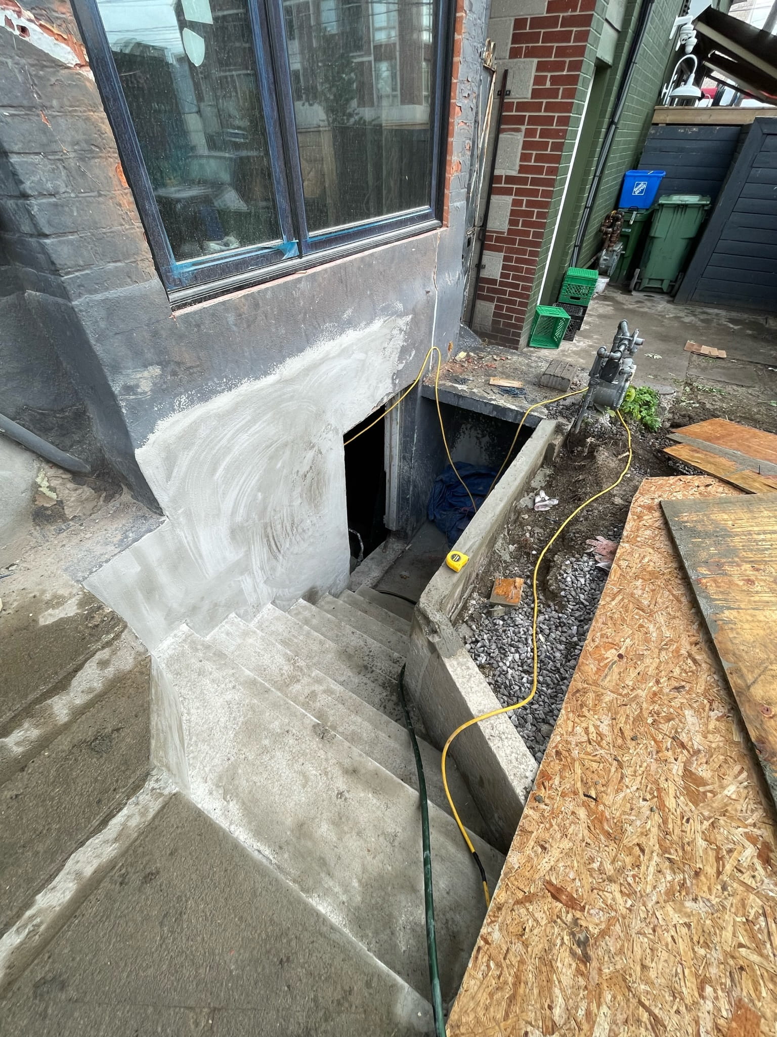 basement-underpinning-toronto-basement-walkouts-willfix Newly constructed basement walkout with concrete steps, waterproofed foundation wall and exterior access opening in Toronto