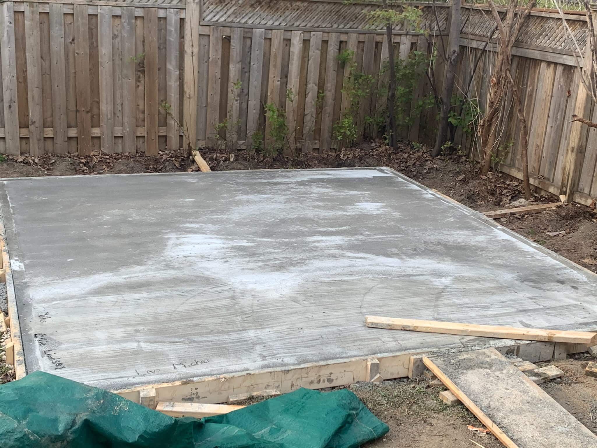 basement-underpinning-toronto-slab-replacement-willfix Freshly poured and finished concrete slab in residential backyard after slab replacement