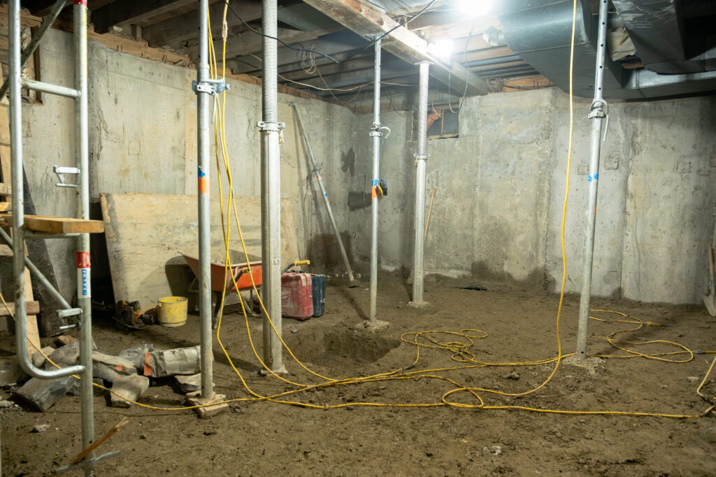 Basement under construction with supports.