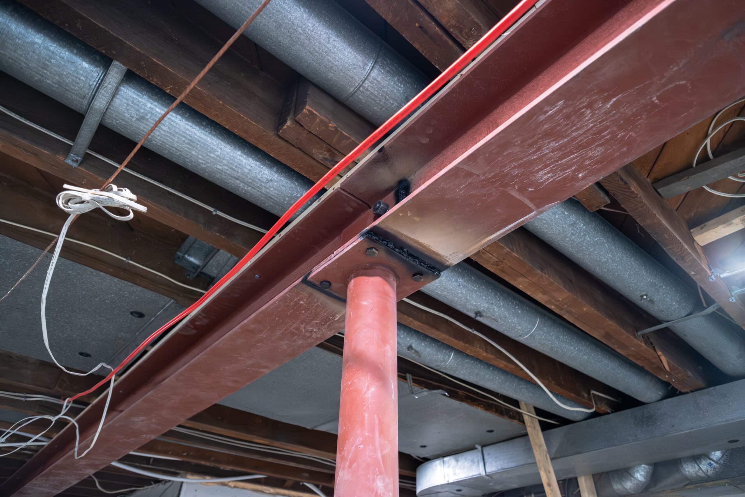 crawl-space-excavation-financing-willfix Basement ceiling with steel beam.